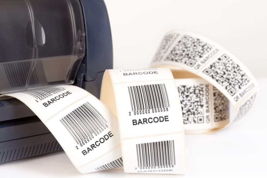 A stream of adhesive labels coming out of a barcode label printer